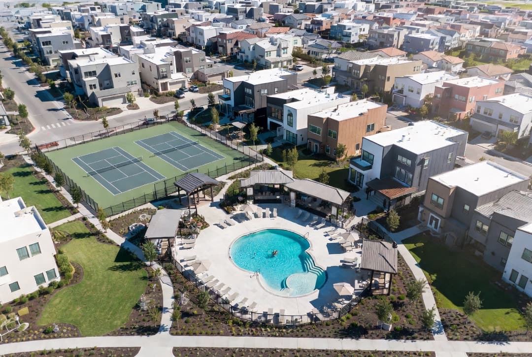 Modern HOA amenity center with pool and tennis courts