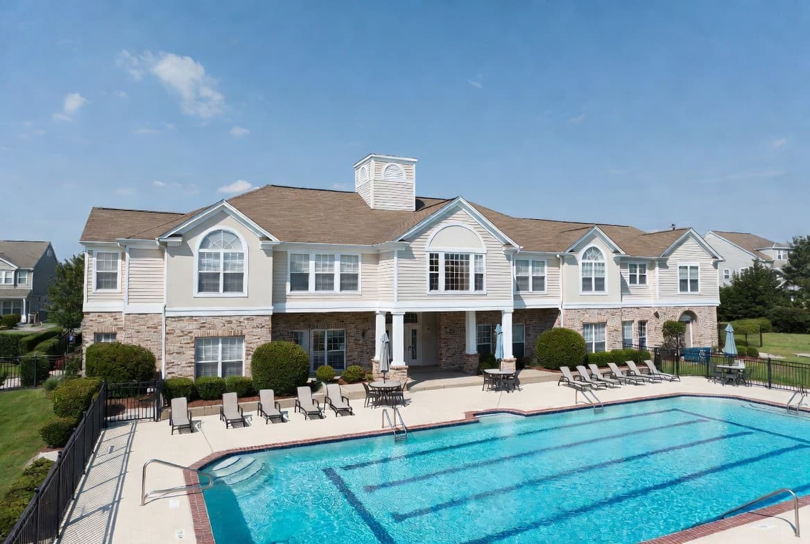 Classic HOA clubhouse with swimming pool and lounge chairs